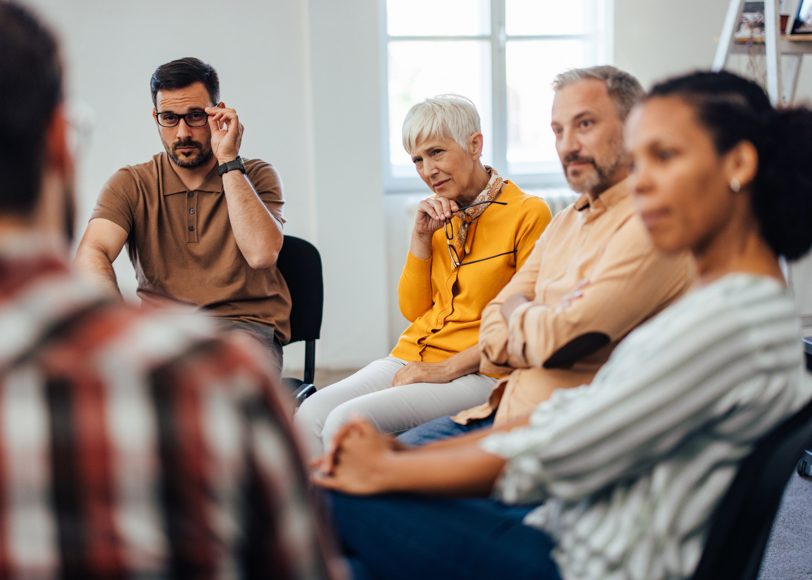 picture of people during a group session listening attentively to the person sharing