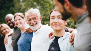 a group of people standing in a line looking at each other in a friendly way