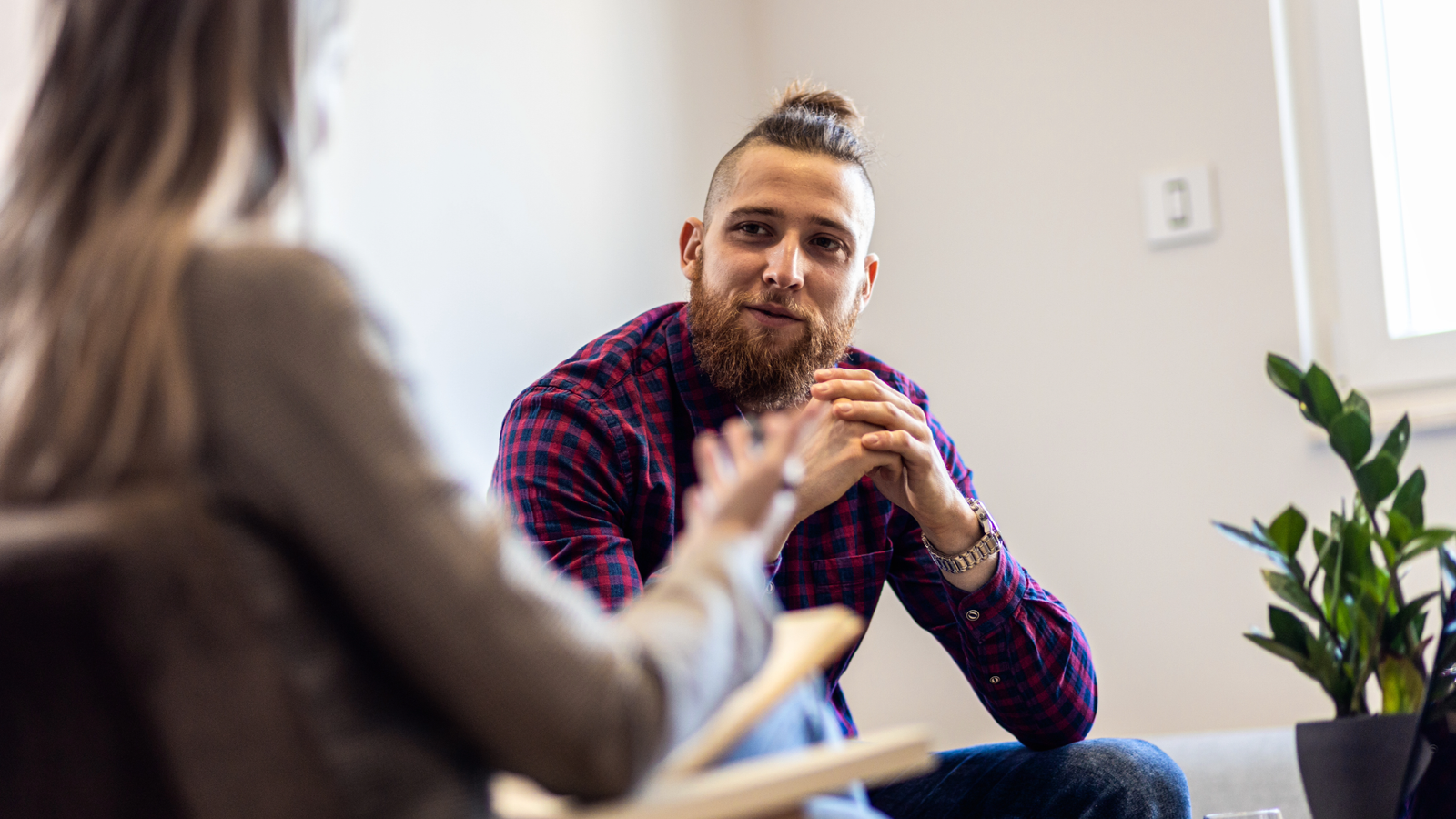 young man listening attentively to a therapist